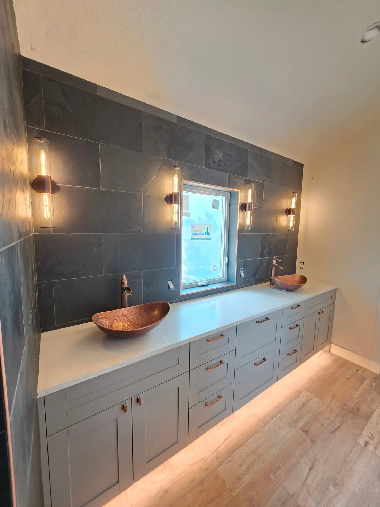 Double vanity with slate tile floor after a bathroom remodel in Golden, CO