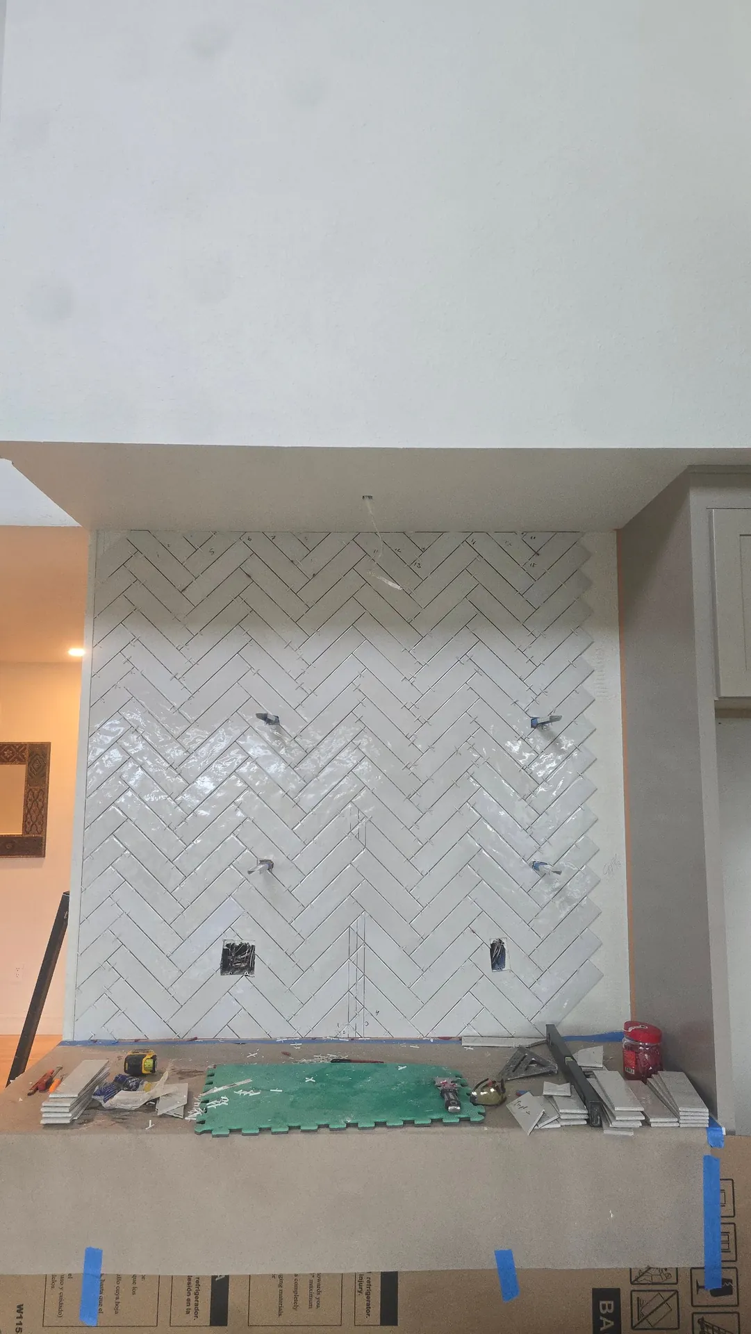 White herringbone backsplash tile going up during a kitchen remodel in Golden, CO