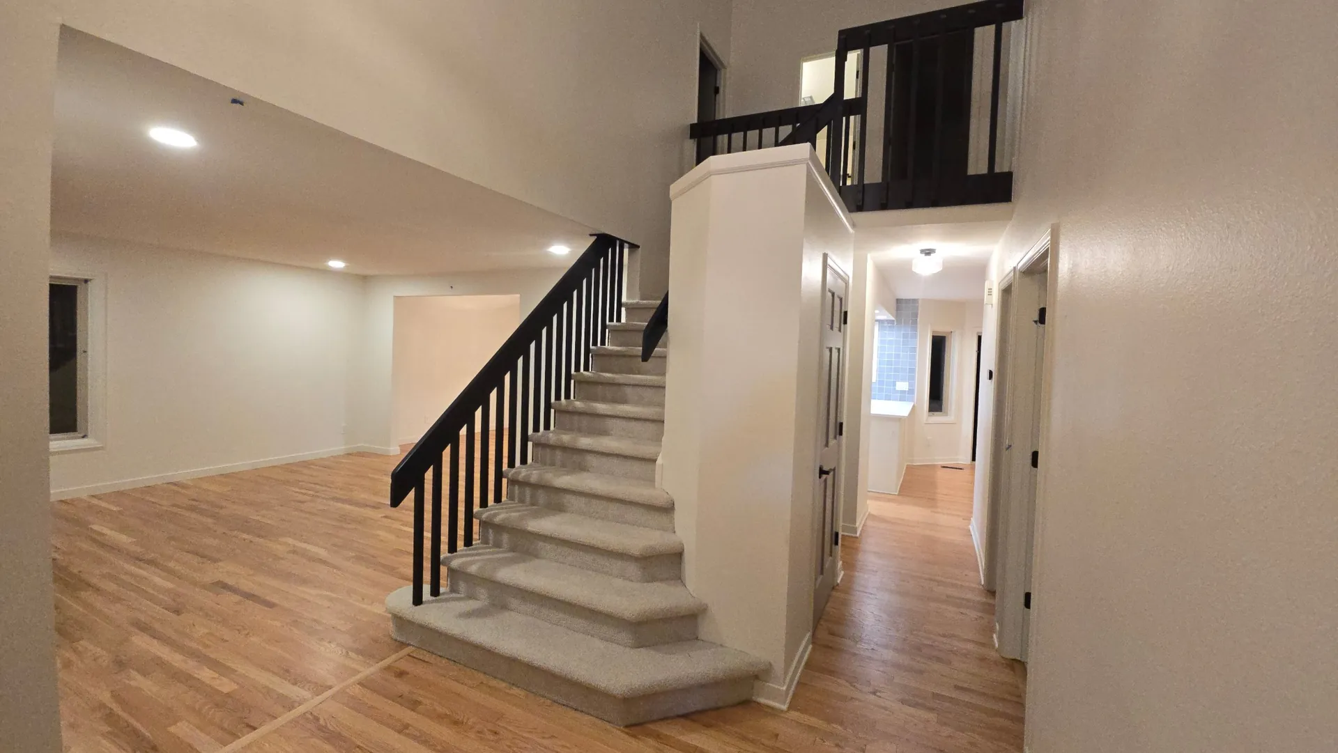 Updated entry with black stair railing and refinished hardwood in Golden, CO