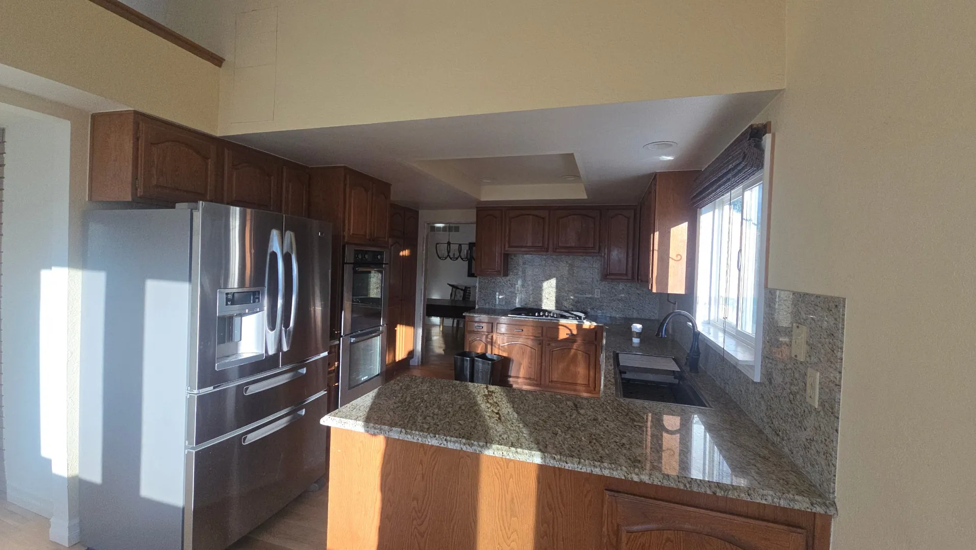 Dated oak and granite kitchen before a remodel in Golden, CO