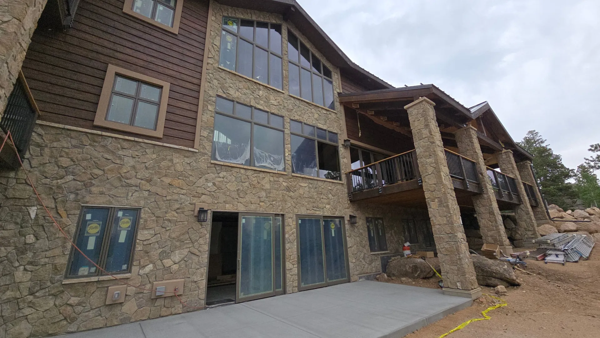Walkout patio and upper deck on a stone and wood home near Golden, CO